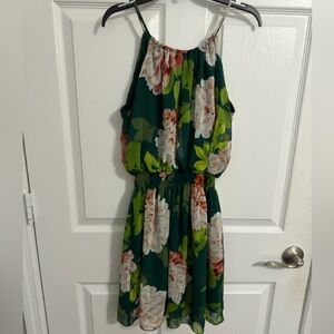 Mini black dress with white flowers and green leaves